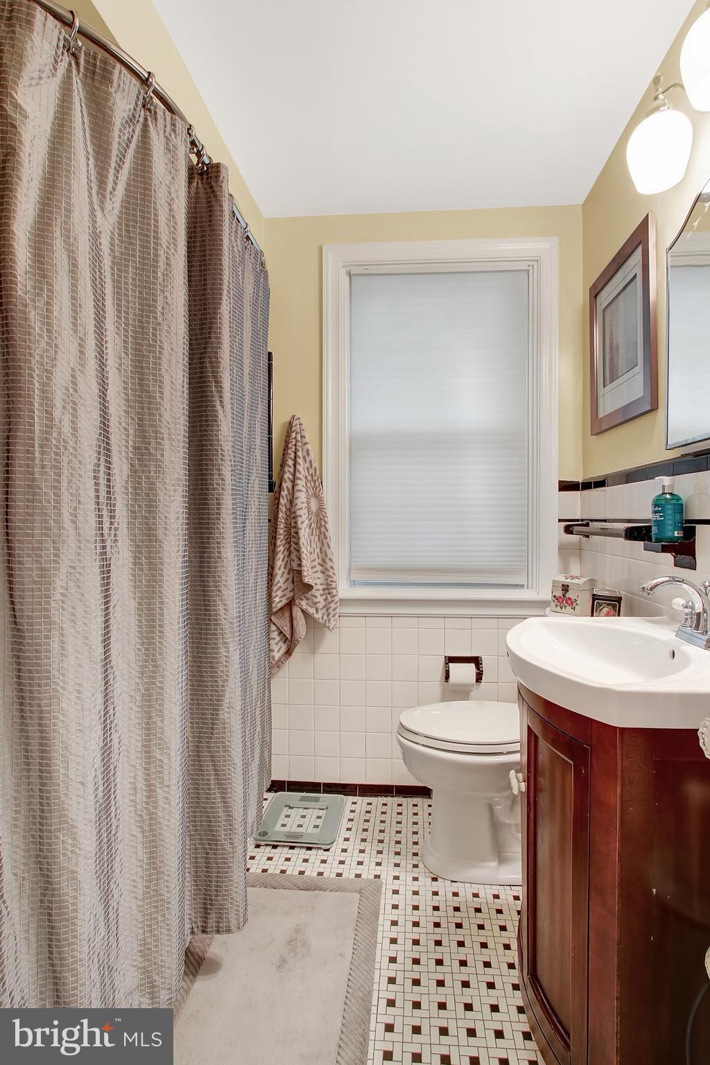 3605 Ednor Road Baltimore, MD 21218 - Photo 12 of 23 a bathroom with a sink a toilet and shower