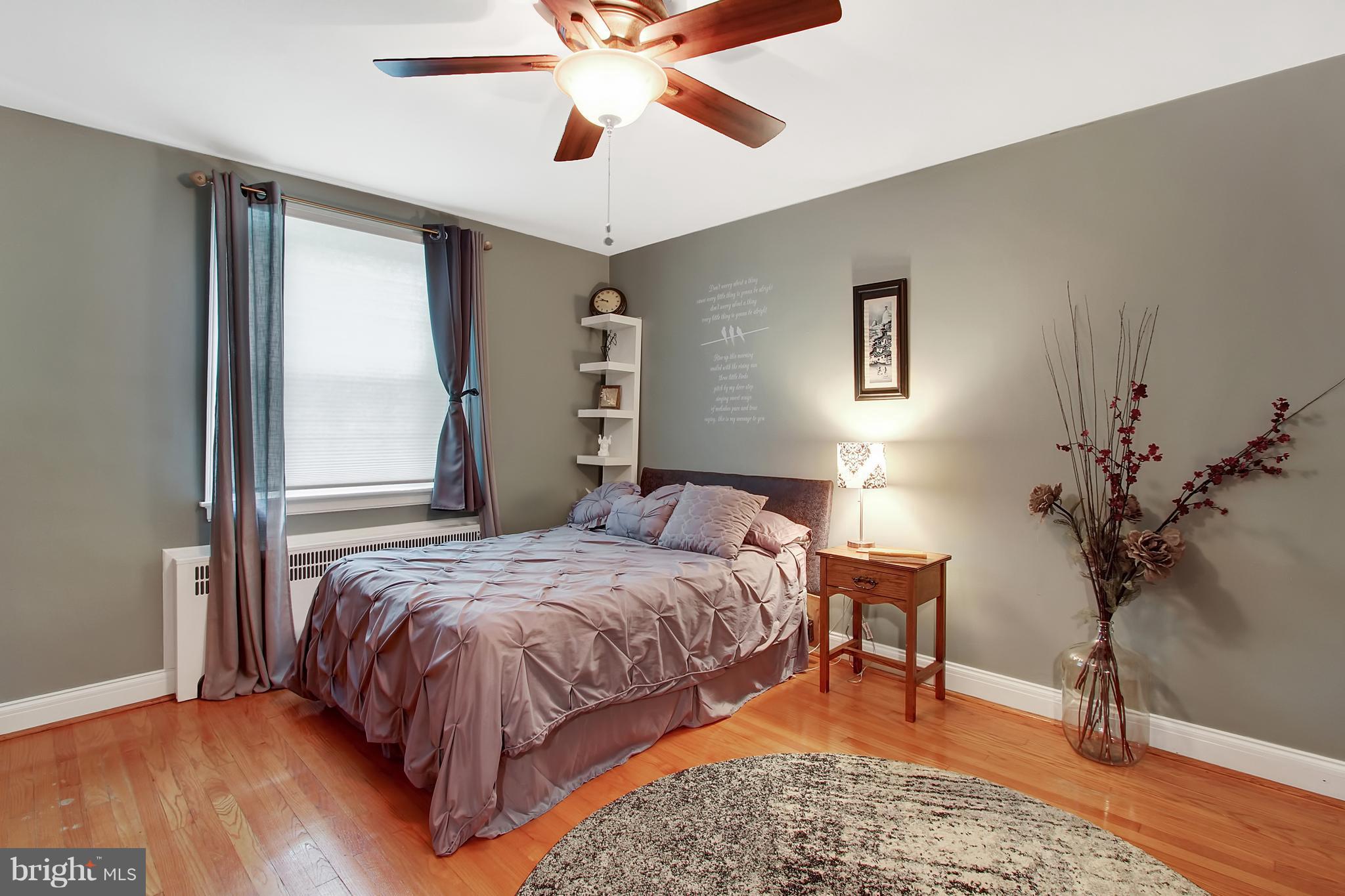 3605 Ednor Road Baltimore, MD 21218 - Photo 13 of 23 a bedroom with a bed and a potted plant