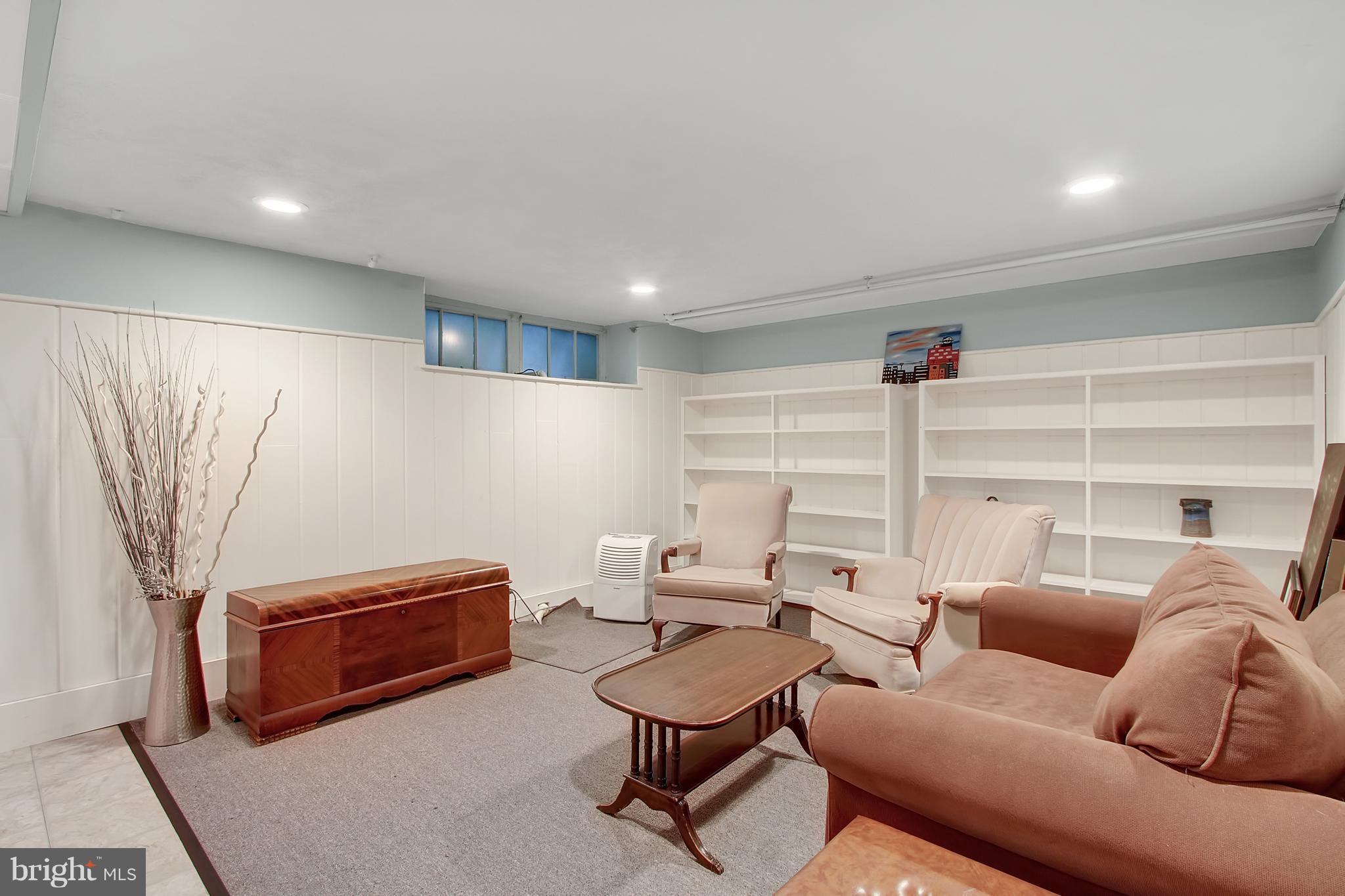 3605 Ednor Road Baltimore, MD 21218 - Photo 18 of 23 a living room with furniture a rug and a projector