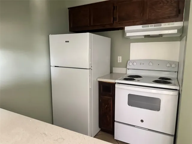 a white refrigerator freezer sitting inside of a kitchen