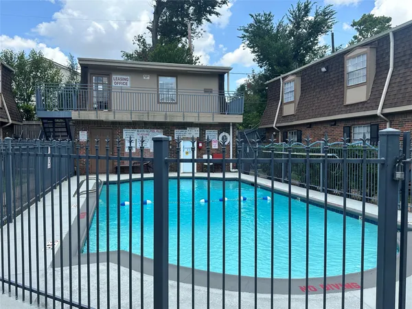 a front view of a house with wooden fence