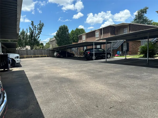 a view of a building with sitting space and trees