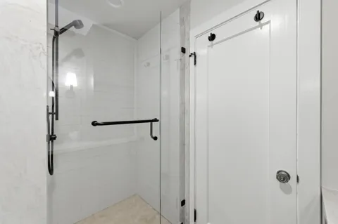 a bathroom with a glass shower door