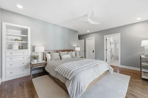 a spacious bedroom with a bed and a dresser