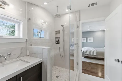 a en suite bathroom with a granite countertop sink