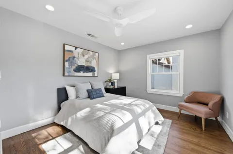 a bedroom with a bed and a chair