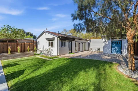 a front view of a house with a yard and porch