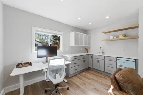 a kitchen with a cabinets and chairs in it