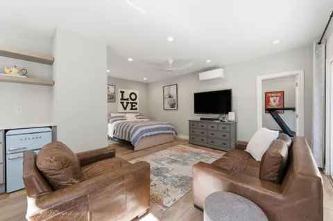 a bedroom with furniture and a flat screen tv