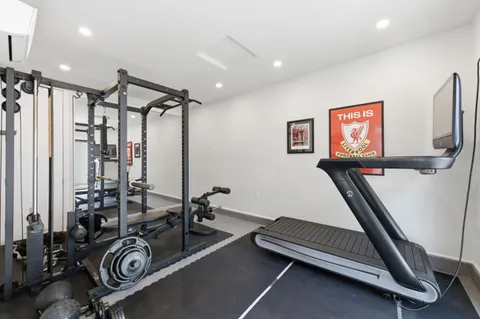 a room with gym equipment and a large window