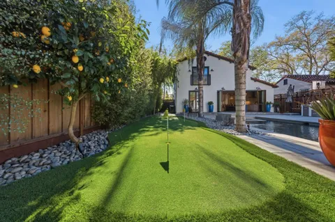 a swimming pool with outdoor seating and yard