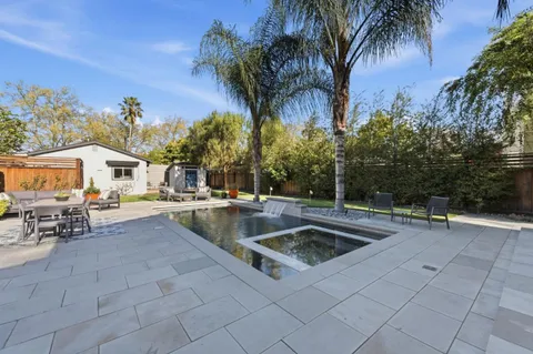 a view of outdoor kitchen with swimming pool and sitting area
