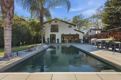 a view of a swimming pool with chairs