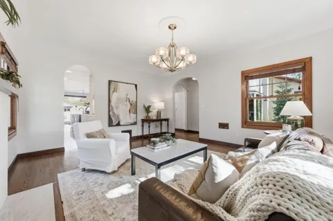 a living room with furniture and a chandelier