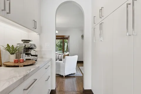 a view of living room with furniture and wooden floor