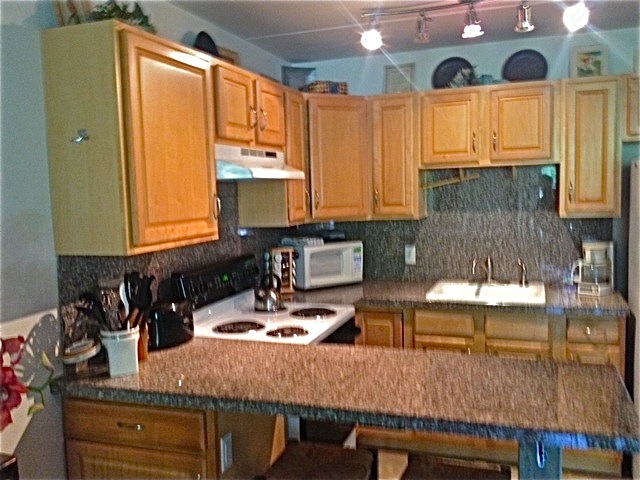 a kitchen with a table chairs and a window