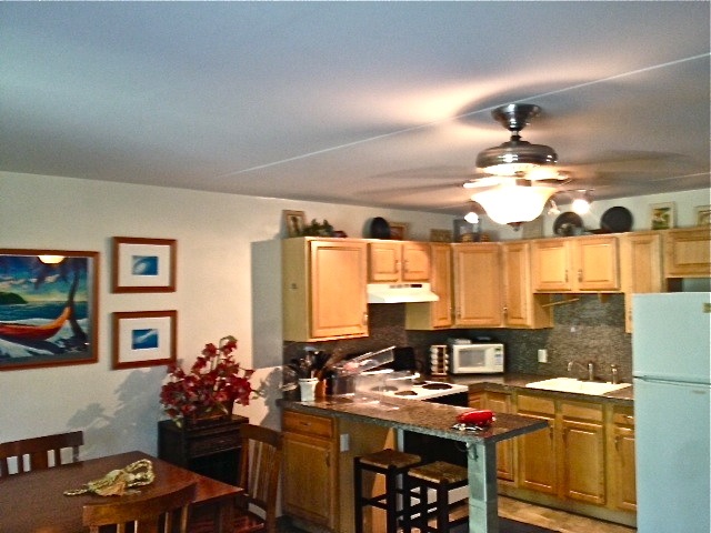 2495 South Kihei Road, Unit 153 Kihei, HI 96753 - Photo 2 of 11 a kitchen with stainless steel appliances a sink stove and window
