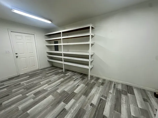a view of walk in closet with empty racks