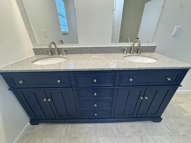 a bathroom with a sink vanity and a mirror