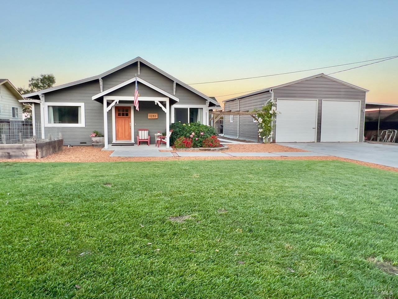 a front view of house with yard and green space