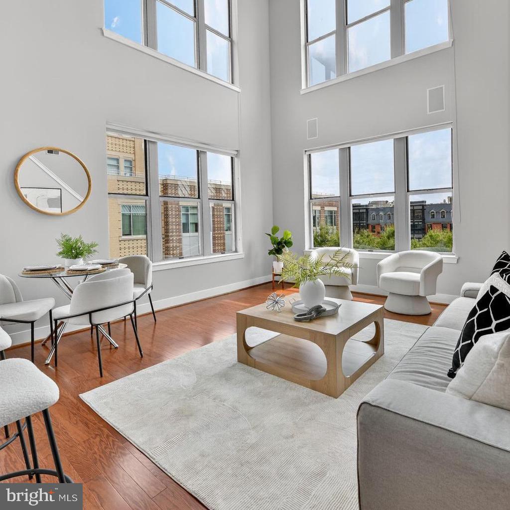 1800 Wilson Boulevard, Unit 449 Arlington, VA 22201 - Photo 23 of 99 a living room with furniture a table and large windows