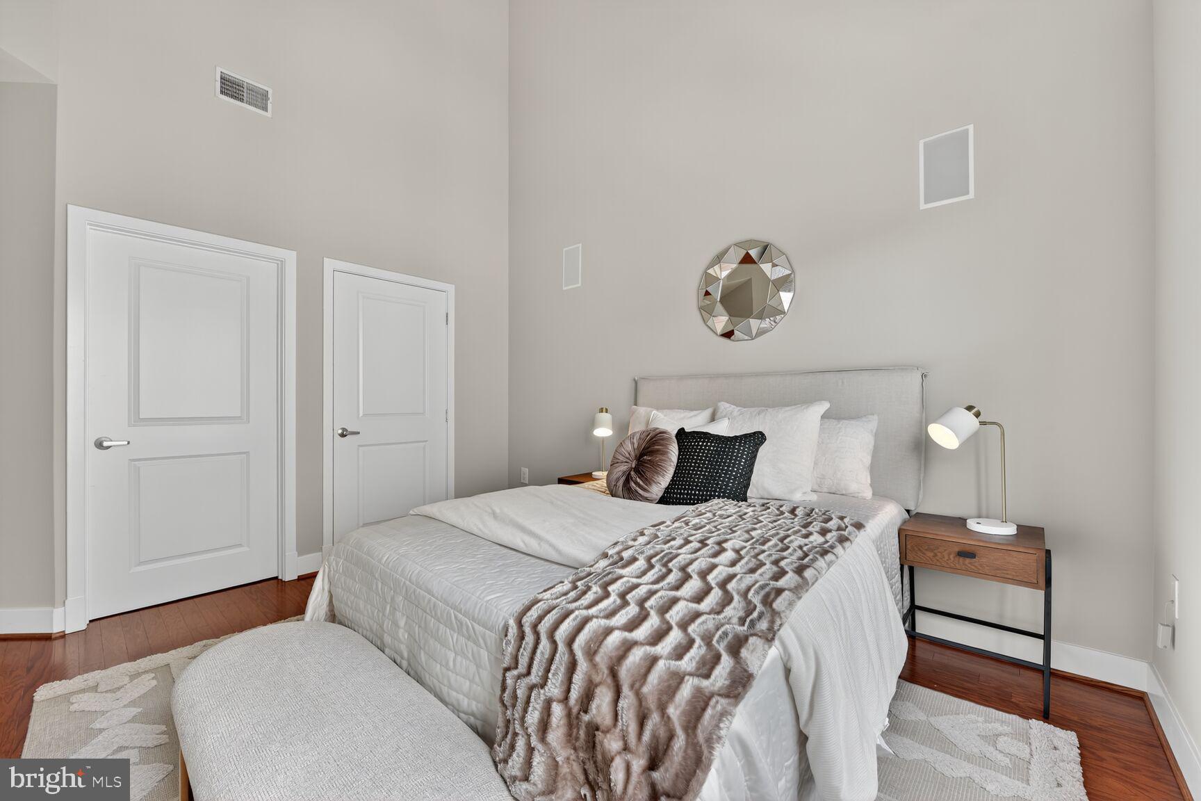 1800 Wilson Boulevard, Unit 449 Arlington, VA 22201 - Photo 36 of 99 a bedroom with a bed and wooden floor