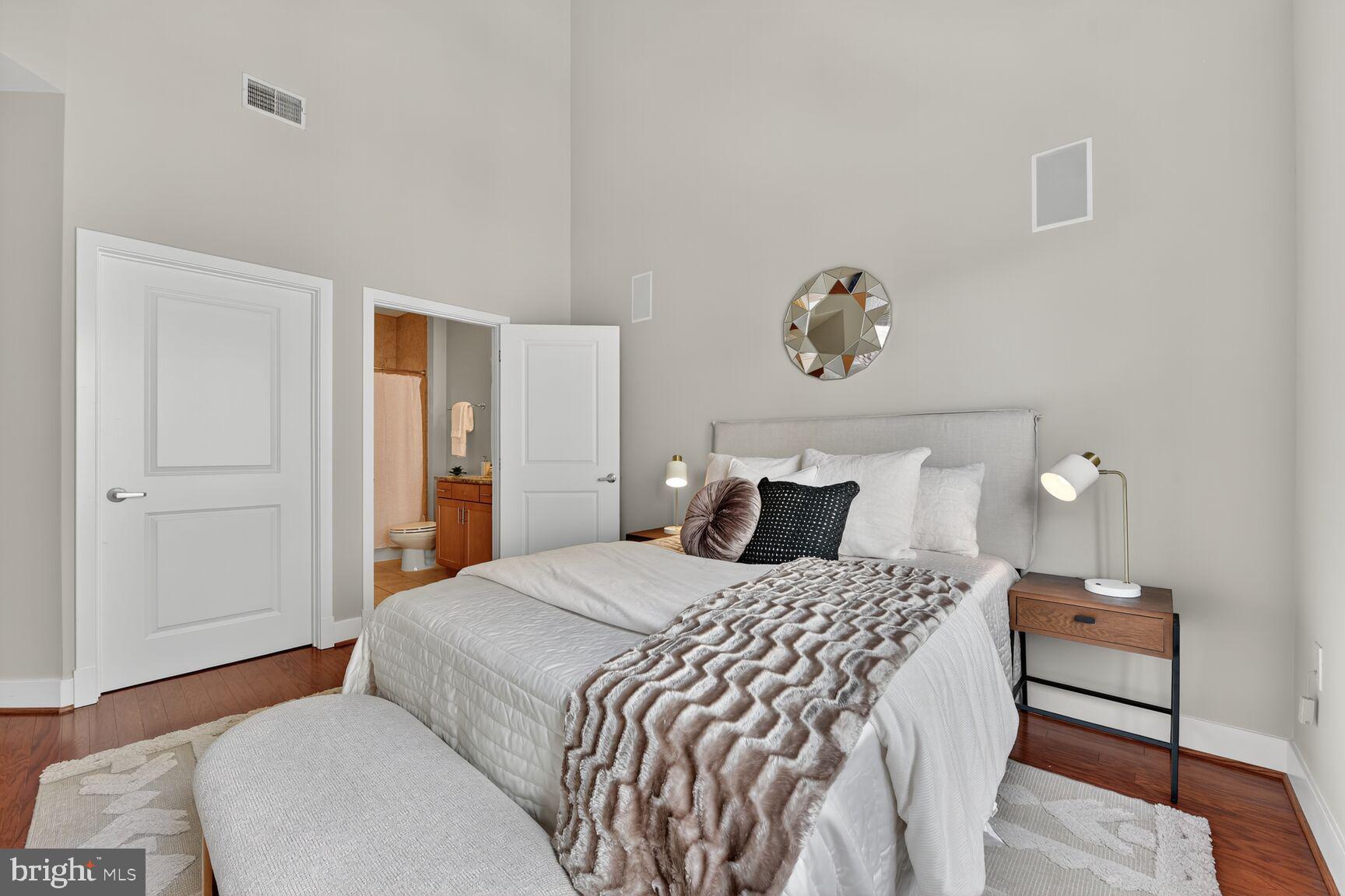 1800 Wilson Boulevard, Unit 449 Arlington, VA 22201 - Photo 37 of 99 a bedroom with a bed and wooden floor