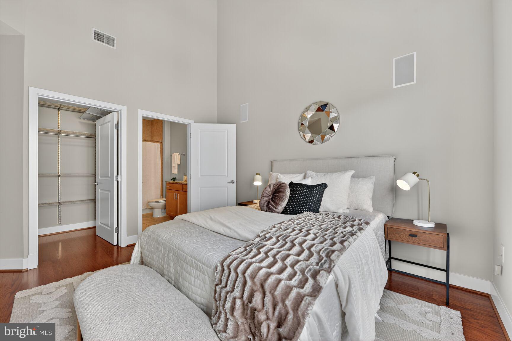 1800 Wilson Boulevard, Unit 449 Arlington, VA 22201 - Photo 38 of 99 a bedroom with a bed and wooden floor