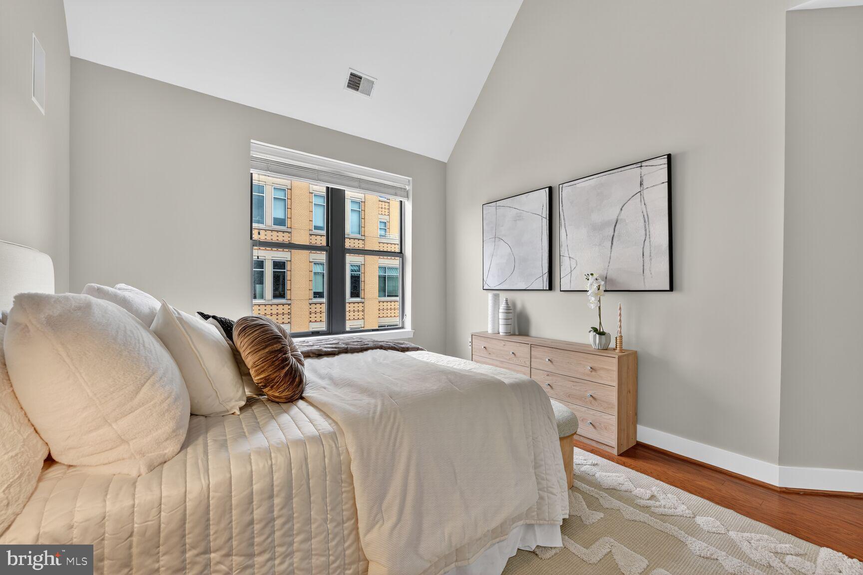 1800 Wilson Boulevard, Unit 449 Arlington, VA 22201 - Photo 39 of 99 a bedroom with a bed painting on wall and a window