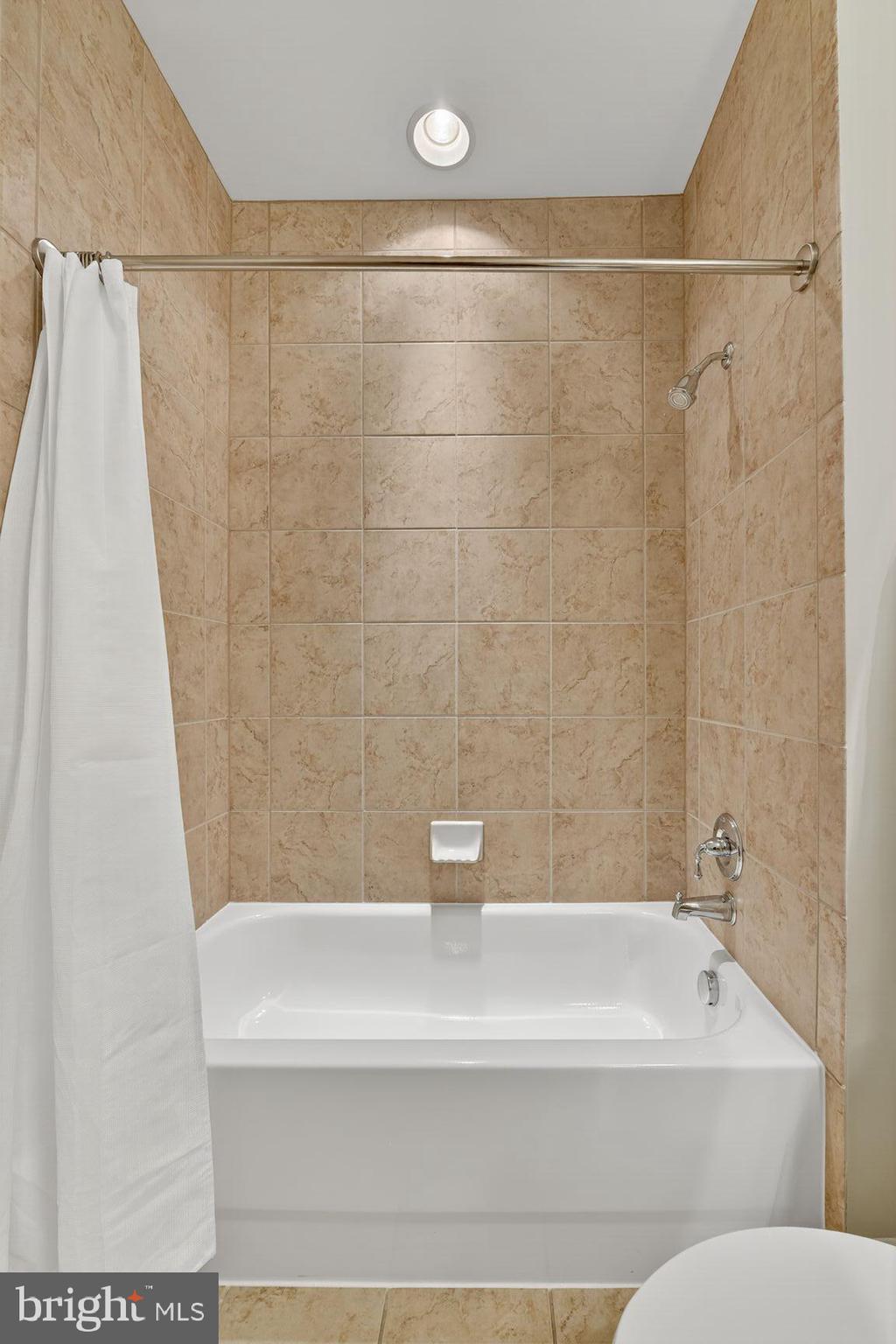 1800 Wilson Boulevard, Unit 449 Arlington, VA 22201 - Photo 48 of 99 a bathroom with a shower and a bath tub