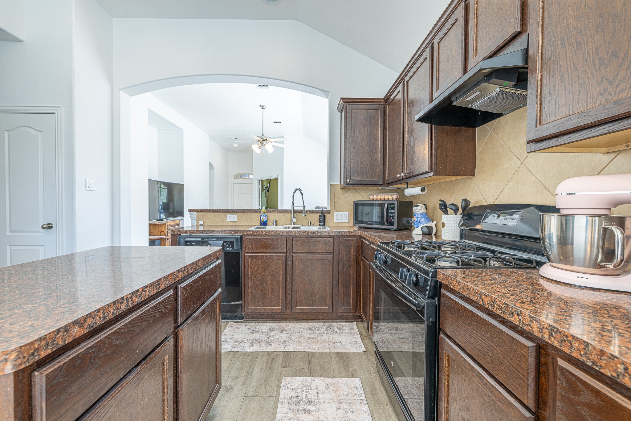 3818 Hunters Trail Baytown, TX 77521 - Photo 10 of 32 a kitchen with stainless steel appliances granite countertop a sink stove and cabinets