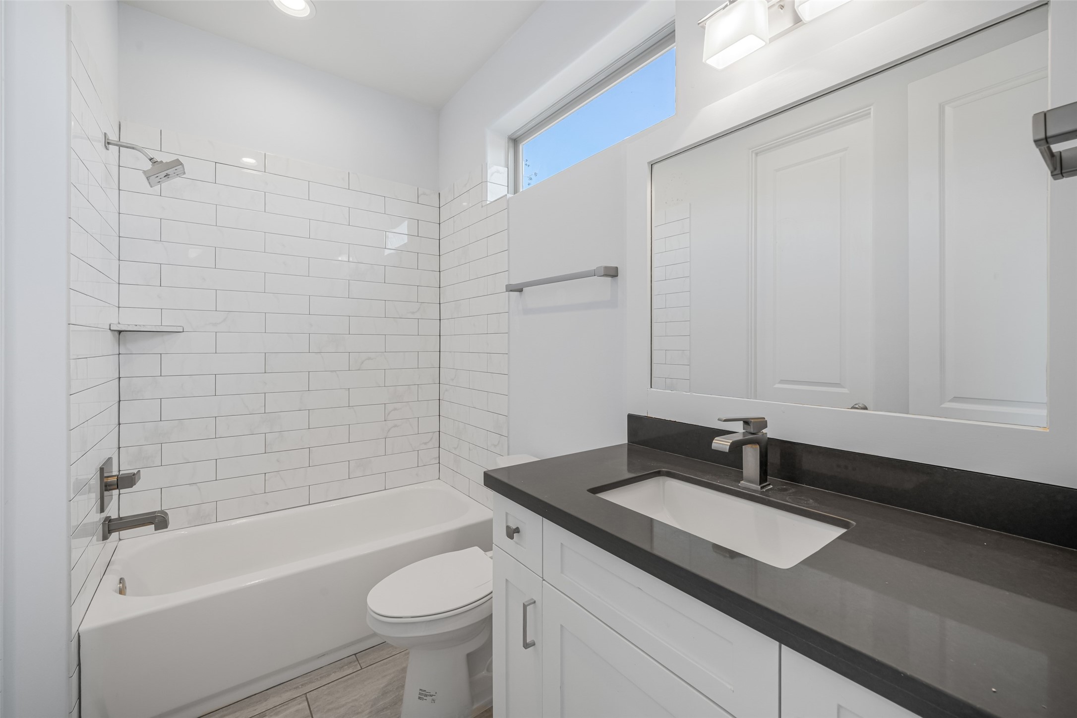 2324 Camden Drive, Unit C Houston, TX 77021 - Photo 22 of 34 a bathroom with a granite countertop sink a toilet a mirror and shower