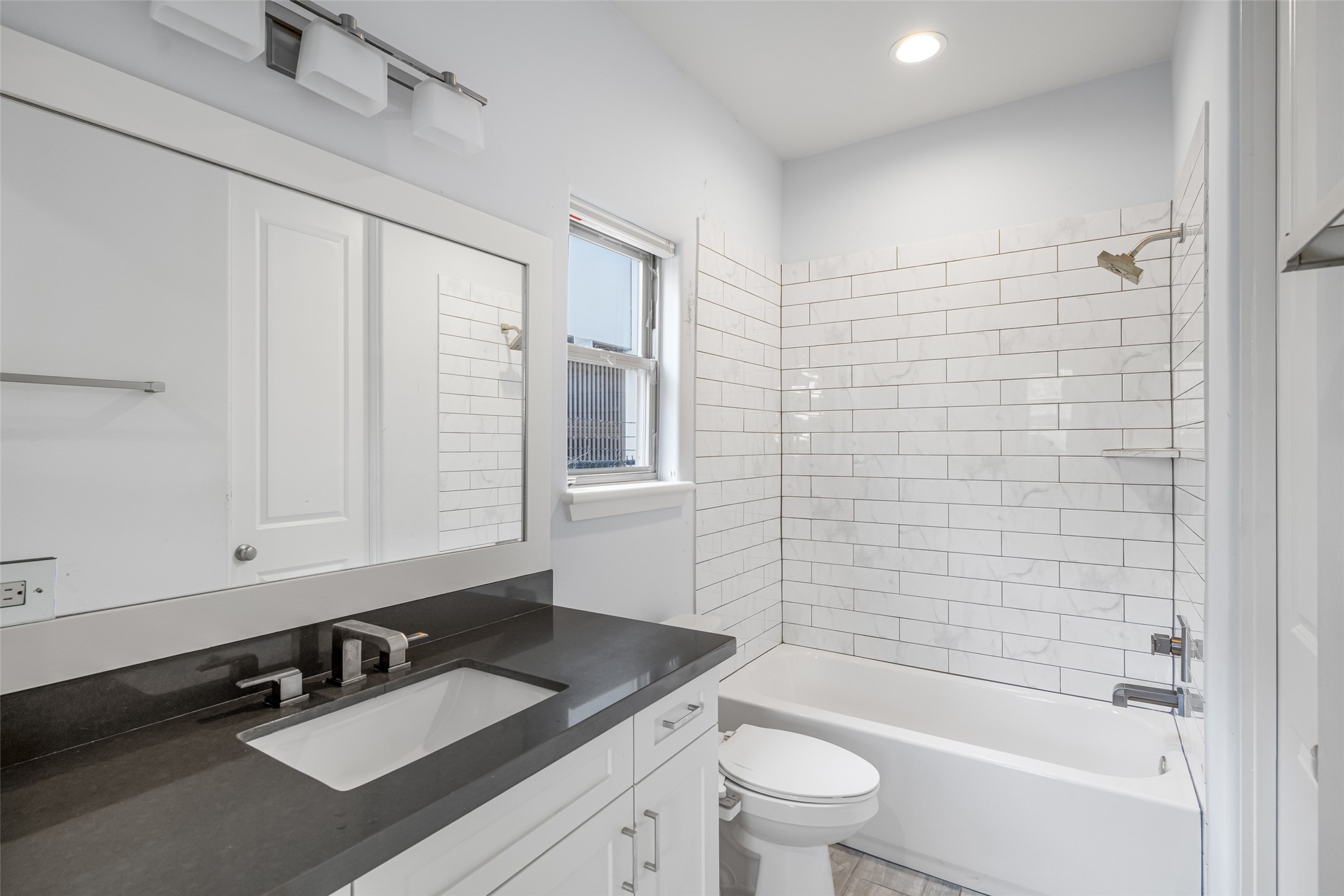 2324 Camden Drive, Unit C Houston, TX 77021 - Photo 5 of 34 a bathroom with a sink a toilet a mirror and shower