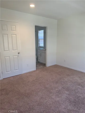 a view of an empty room and closet area