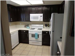 348 Seine Way Henderson, NV 89014 - Photo 4 of 7 Kitchen featuring white appliances, light countertops, and light tile patterned flooring