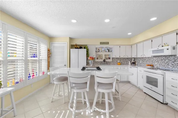a kitchen with a sink and white cabinets