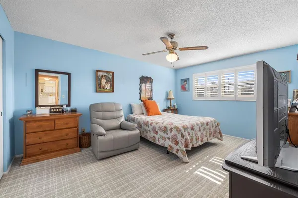a bedroom with a bed and a flat screen television