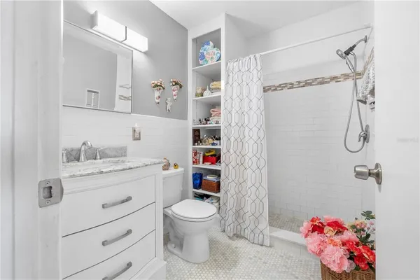 a bathroom with a sink mirror vanity and toilet
