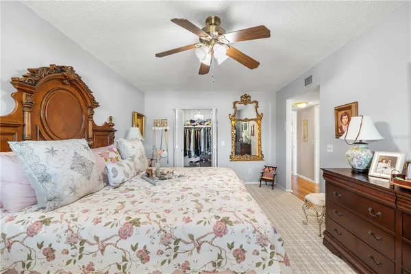 a bedroom with a large bed and a chandelier