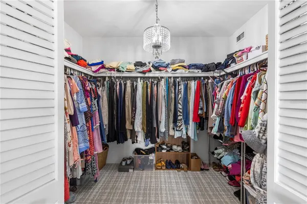a view of walk in closet with clothes