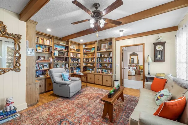 a living room with furniture and a book shelf