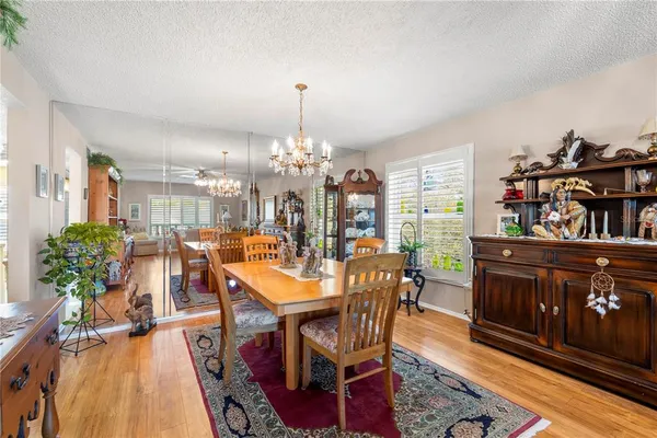 a view of a dining room with furniture and chandelier