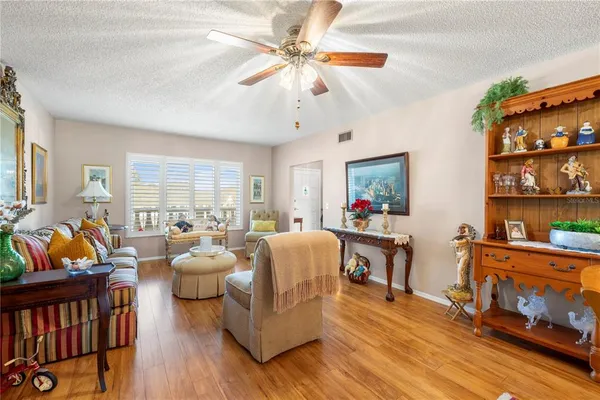 a living room with furniture a rug and a window