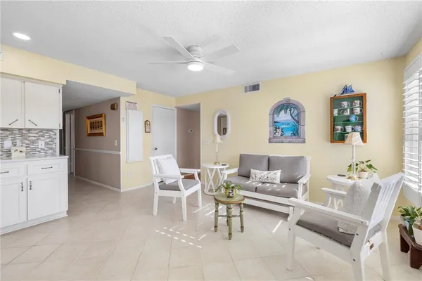 a living room with furniture and a kitchen