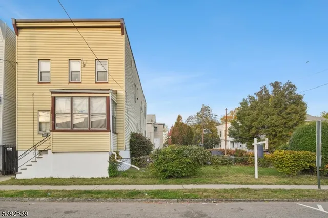 a view of a brick house with a yard