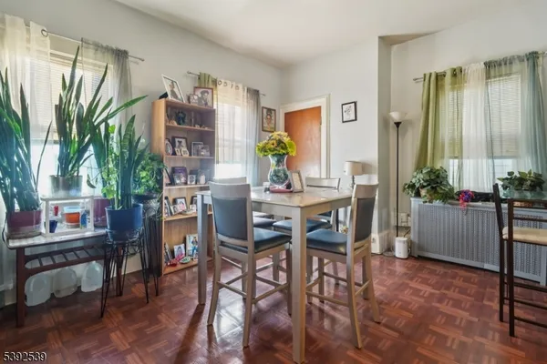 a view of a dining room with furniture and a potted plant