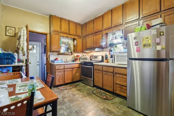 a kitchen with refrigerator cabinets and wooden floor