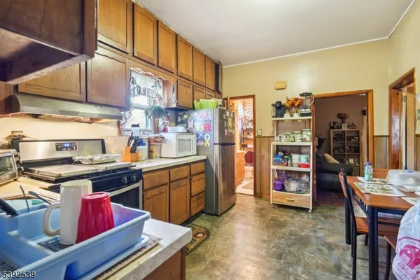 a kitchen with stainless steel appliances granite countertop a stove and a refrigerator
