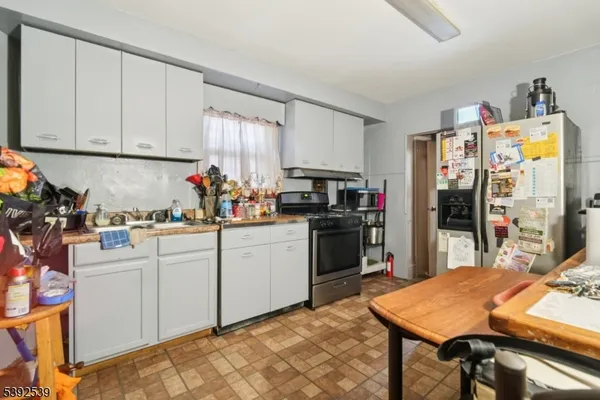a kitchen with stainless steel appliances granite countertop a refrigerator sink and cabinets