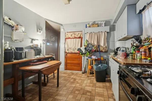 a kitchen with stainless steel appliances kitchen island granite countertop a table and chairs in it